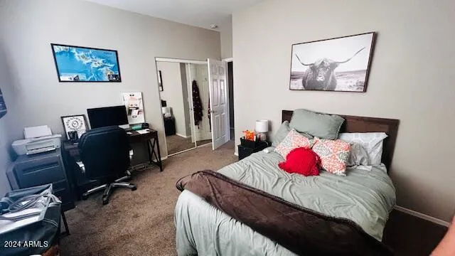 a bedroom with a bed and a desk