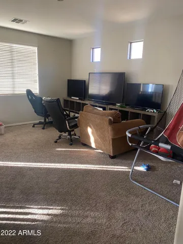 a room with gym equipment and a flat screen tv