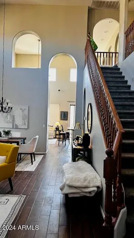a living room with furniture a piano and white walls