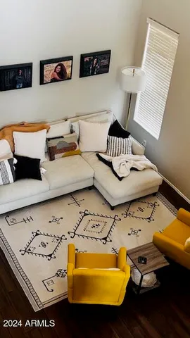 a living room with furniture and lamp