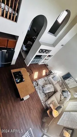 a living room with furniture and floor to ceiling window