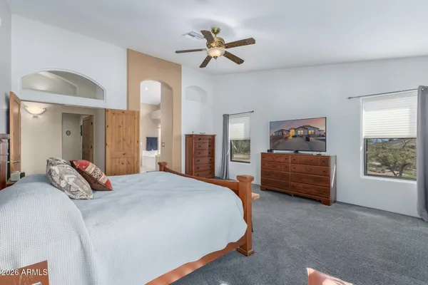 a bedroom with a bed dresser and a window