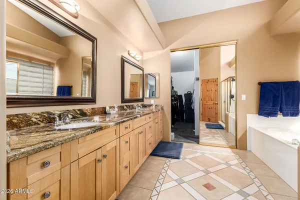 a large bathroom with a double vanity sink and a large mirror