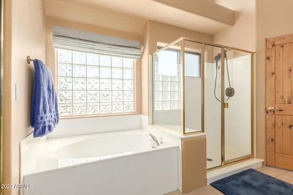 a spacious bathroom with a bathtub and shower