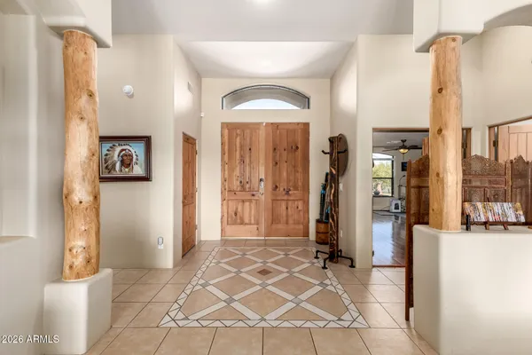 a view of a hallway with wooden floor and a living room