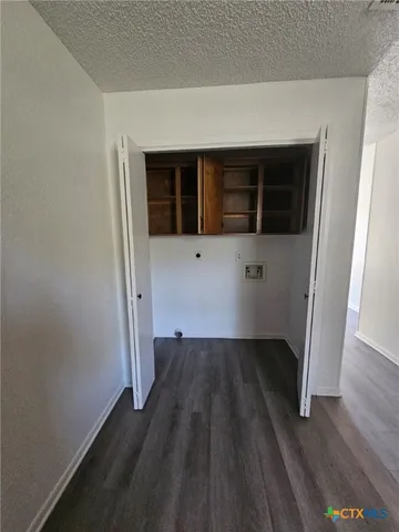 a view of a hallway with wooden floor and stairs