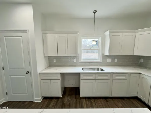 a kitchen with sink and cabinets