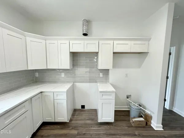 a view of kitchen and hall with wooden floor