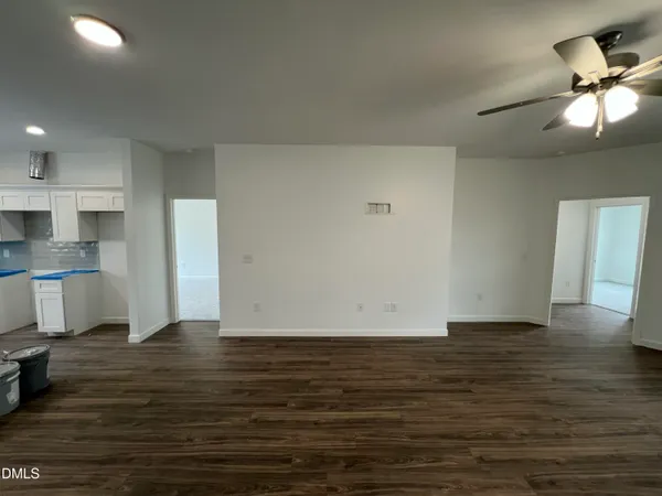 a large white kitchen with a large window