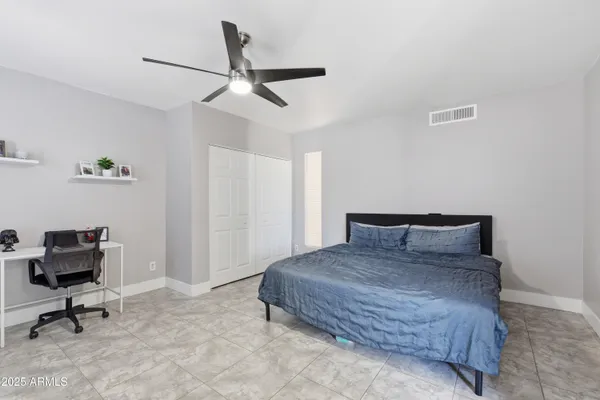 a bedroom with a bed and a desk