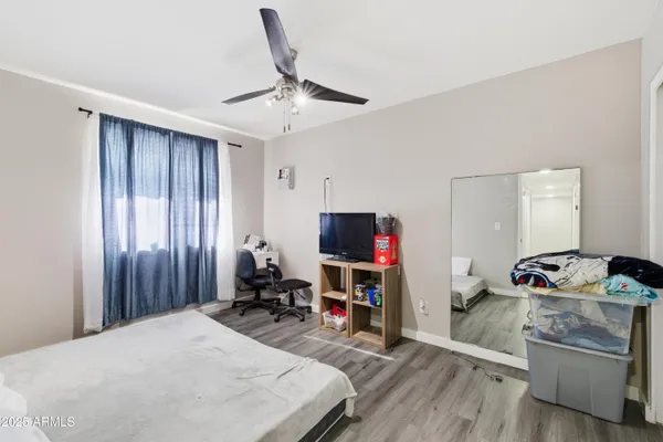 a bed room with a bed and a television