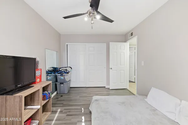 a bedroom with furniture and a flat screen tv
