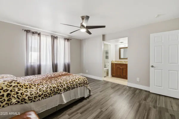 a bedroom with a large bed and a chandelier