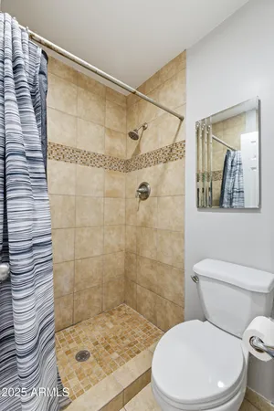 a bathroom with a toilet and shower