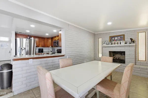 a large kitchen with cabinets table and chairs