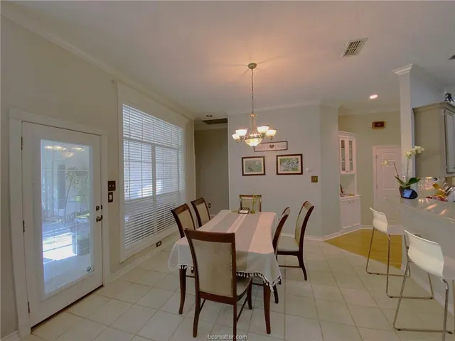 a view of a dining room with furniture and window