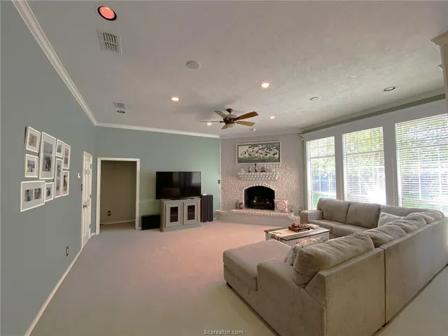 a living room with fireplace furniture and a flat screen tv