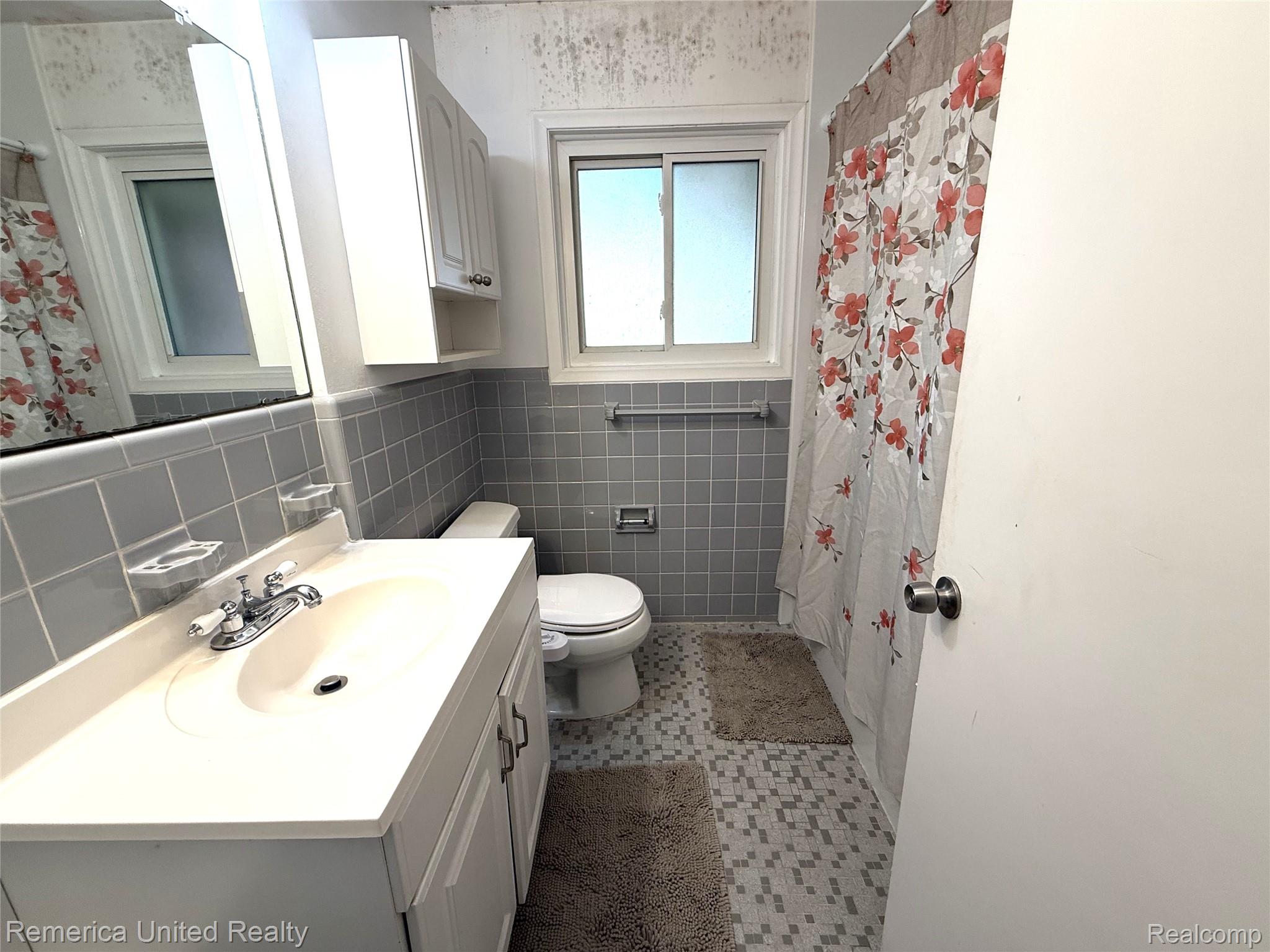 28231 Farmington Road Farmington, MI 48334 - Photo 13 of 18 Bathroom featuring vanity and tile walls
