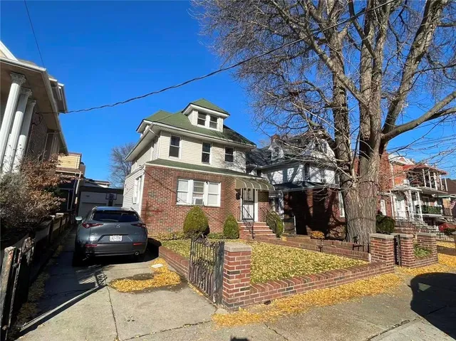 a front view of a building with a garden