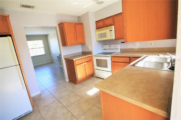 a kitchen with stainless steel appliances granite countertop a sink and a stove top oven