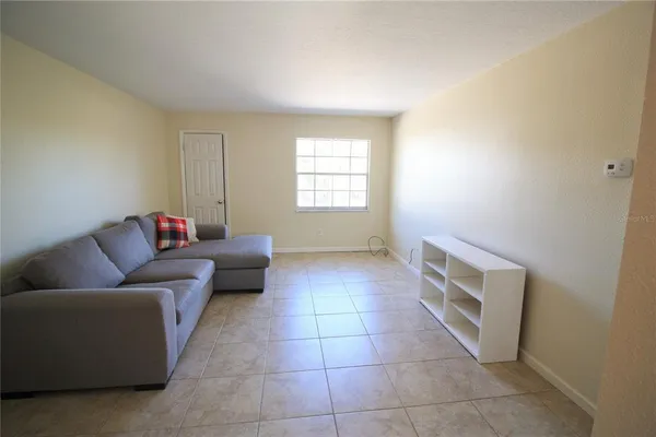 a living room with a couch and a window