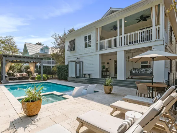 a view of a patio with swimming pool table and chairs