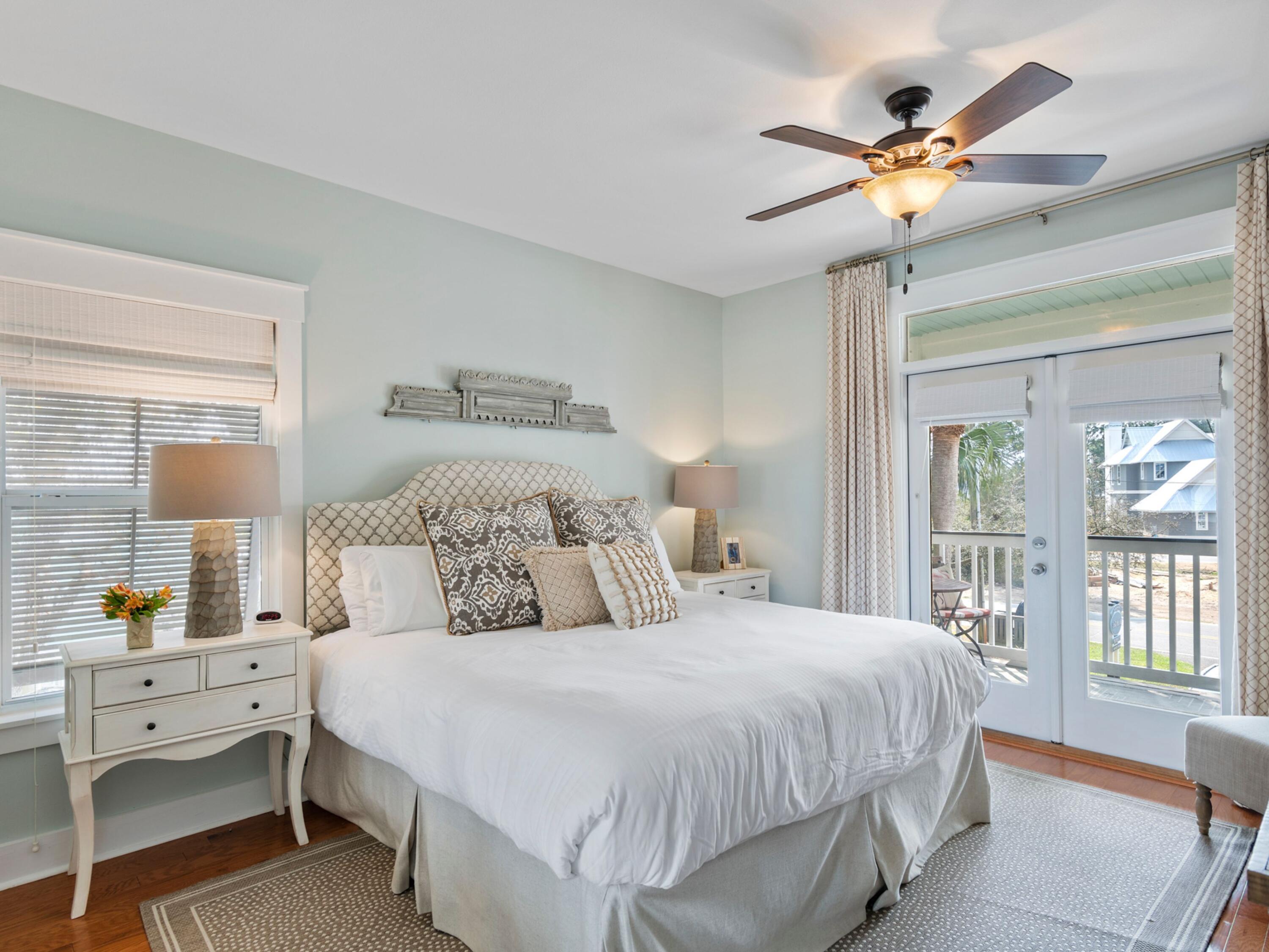 499 Lakeview Drive Santa Rosa Beach, FL 32459 - Photo 13 of 52 a bedroom with a large bed and a chandelier