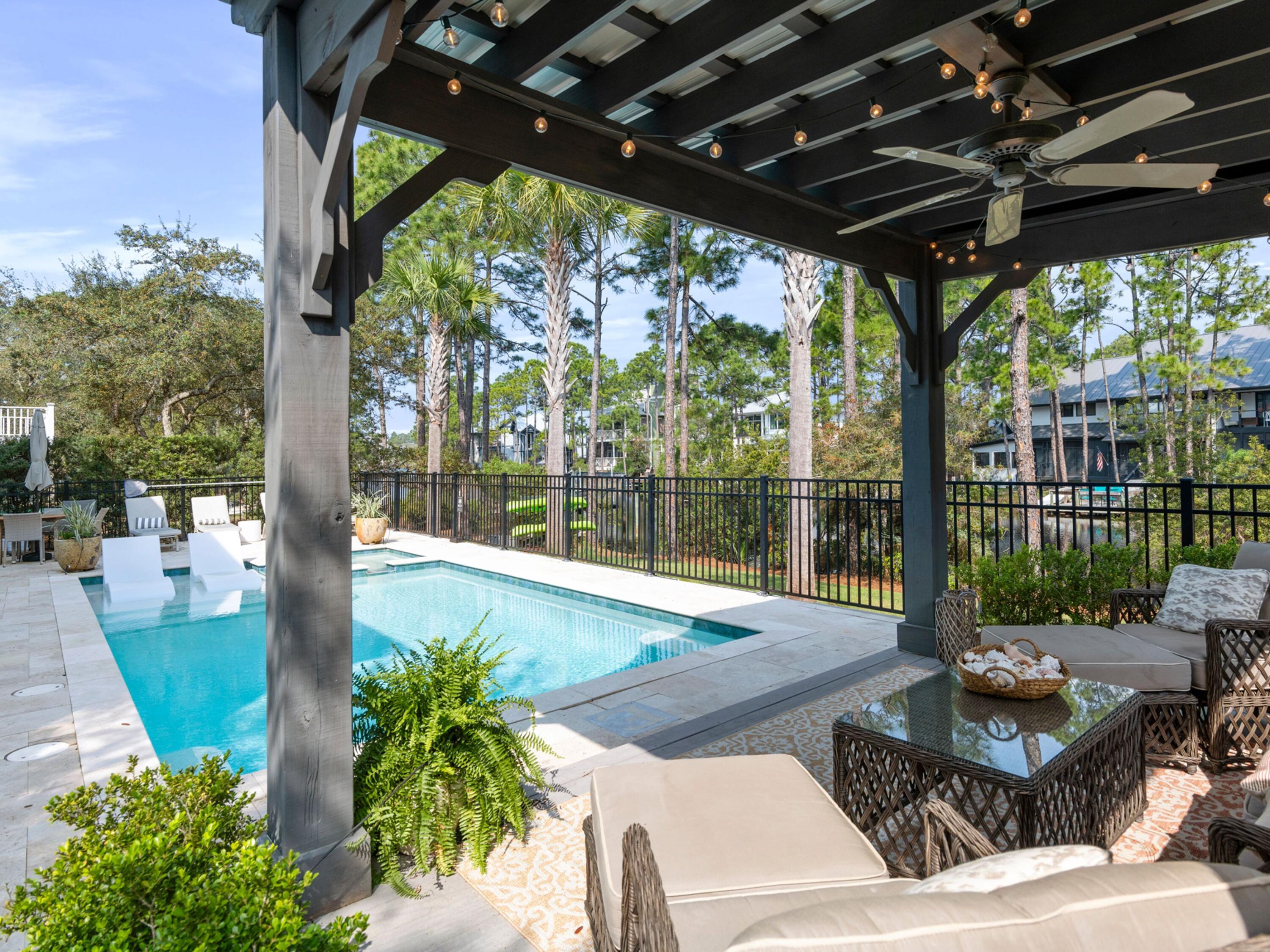 499 Lakeview Drive Santa Rosa Beach, FL 32459 - Photo 52 of 52 a view of a patio with couches plants and wooden floor