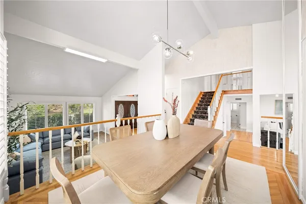 a dining room with furniture and wooden floor