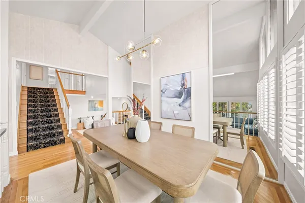 a dining room with furniture and wooden floor