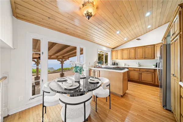 a kitchen with a table chairs stove and cabinets