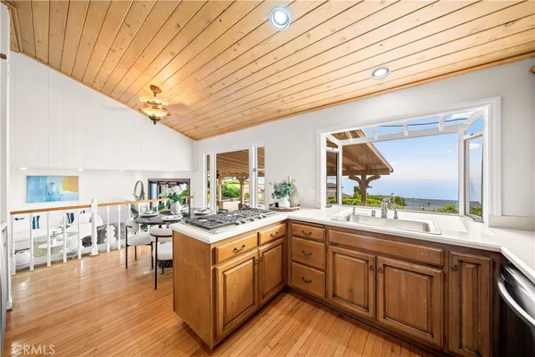 a kitchen with a sink and wooden cabinets
