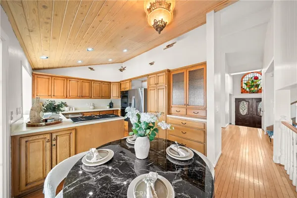 a kitchen with stainless steel appliances granite countertop a stove and white cabinets