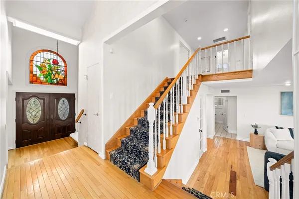 a view of an entryway with wooden floor