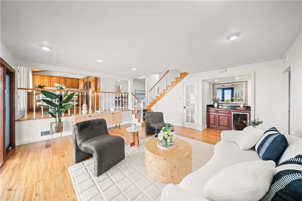 a living room with furniture and a wooden floor