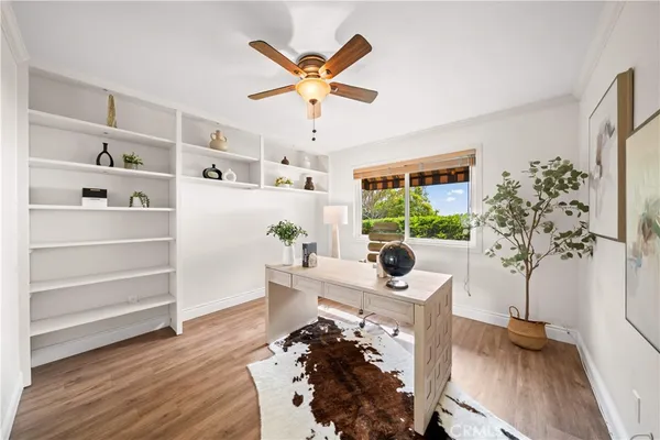 a spacious bedroom with a bed and wooden floor
