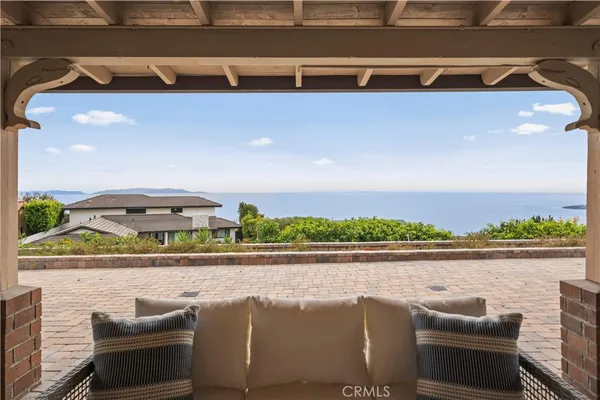 a view of a patio with a table chairs and a floor to ceiling window
