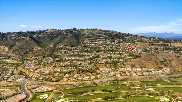 an aerial view of a house with garden space and street view