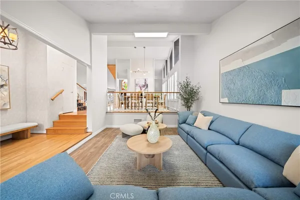 a living room with furniture and a dining table