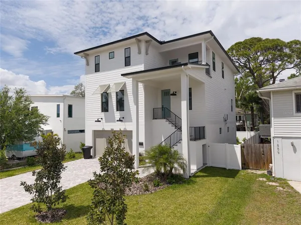 a front view of a house with a garden