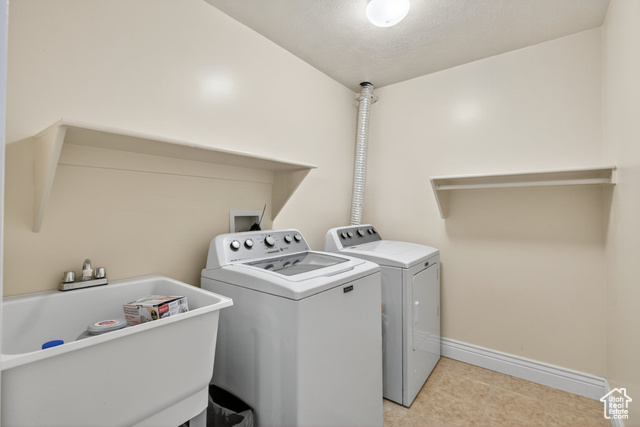 4768 East Hickman Canyon Road Stockton, UT 84071 - Photo 52 of 85 Basement laundry room featuring separate washer and dryer and shelfs.