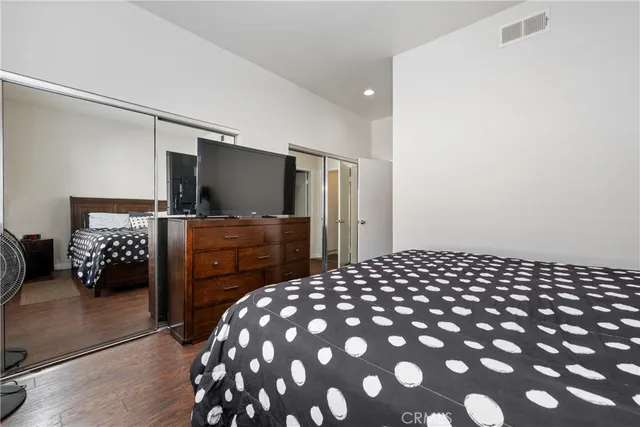 a bedroom with a bed and a television