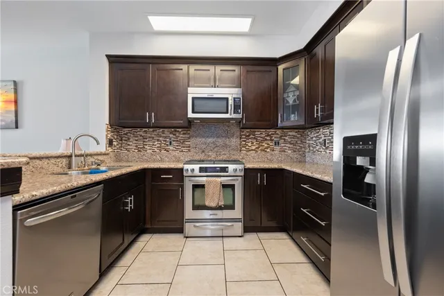 a kitchen with a refrigerator and a sink