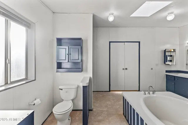 a bathroom with a tub shower and sink