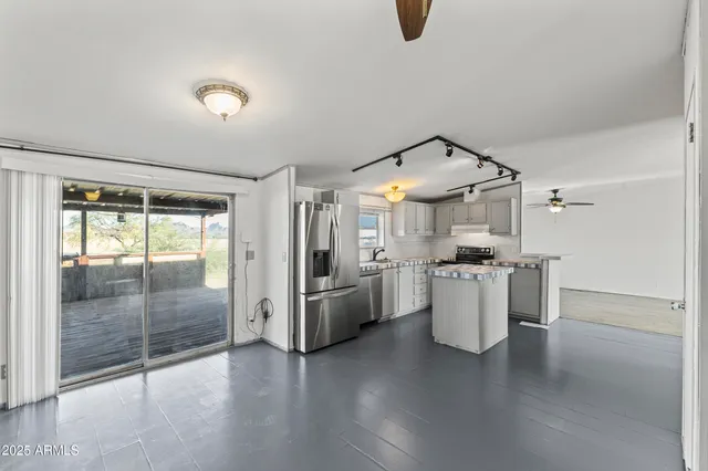 a kitchen with stainless steel appliances a refrigerator sink and cabinets