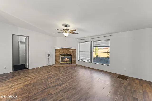 a kitchen with a refrigerator and white cabinets