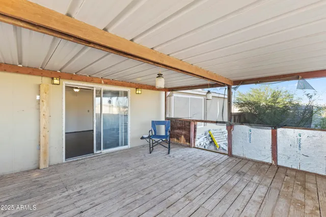 a view of a porch with wooden floor