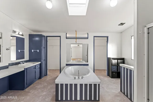 a view of a room with a ceiling fan and hardwood floor