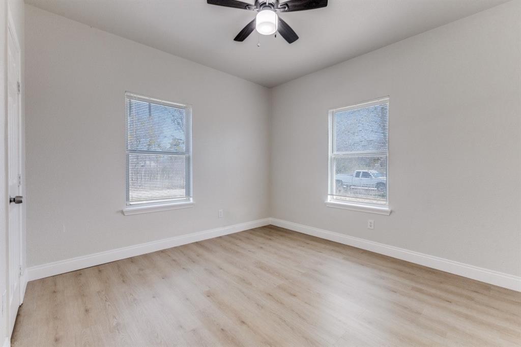 711 South 3rd Avenue East Dawson, TX 76639 - Photo 10 of 12 a view of an empty room with a window and wooden floor