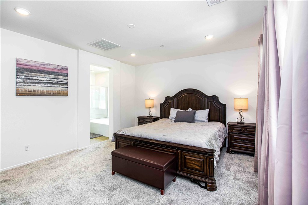 14563 Gulfstream Lane Moreno Valley, CA 92553 - Photo 11 of 30 a bedroom with a bed and a painting